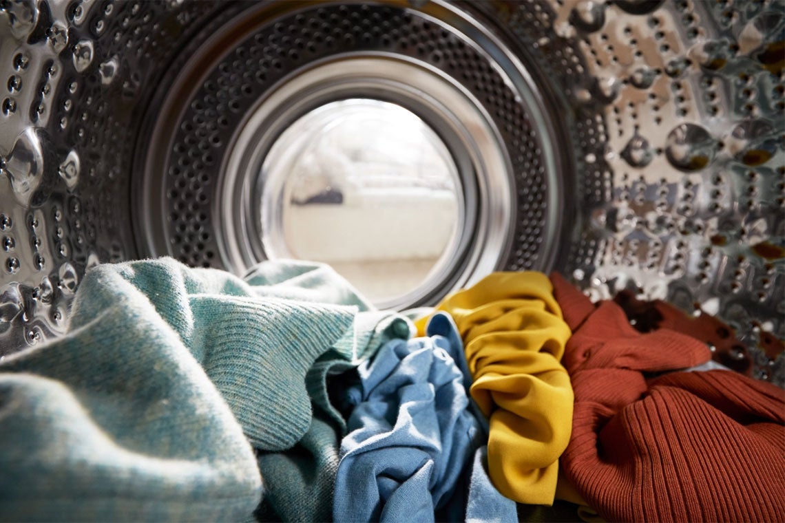 view from the inside of a front load washing machine full of clothes